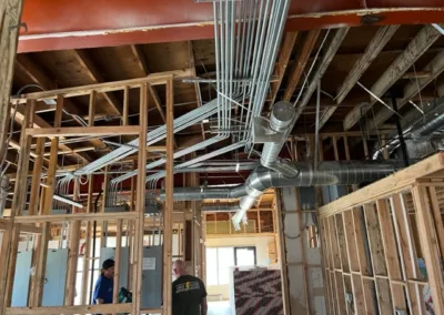 A group of people standing in a building that is under construction.